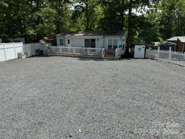 a front view of house with yard and trees in the background