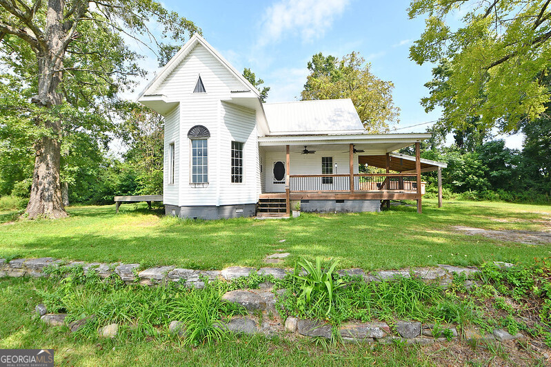 a front view of house with yard and green space