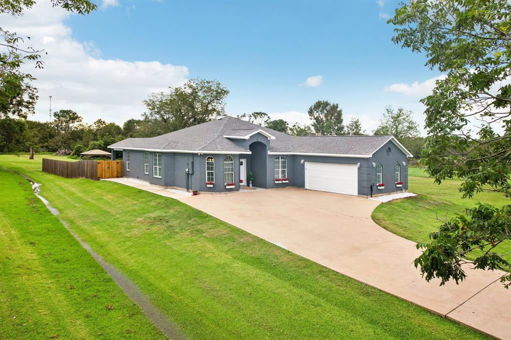 a front view of house with yard and green space