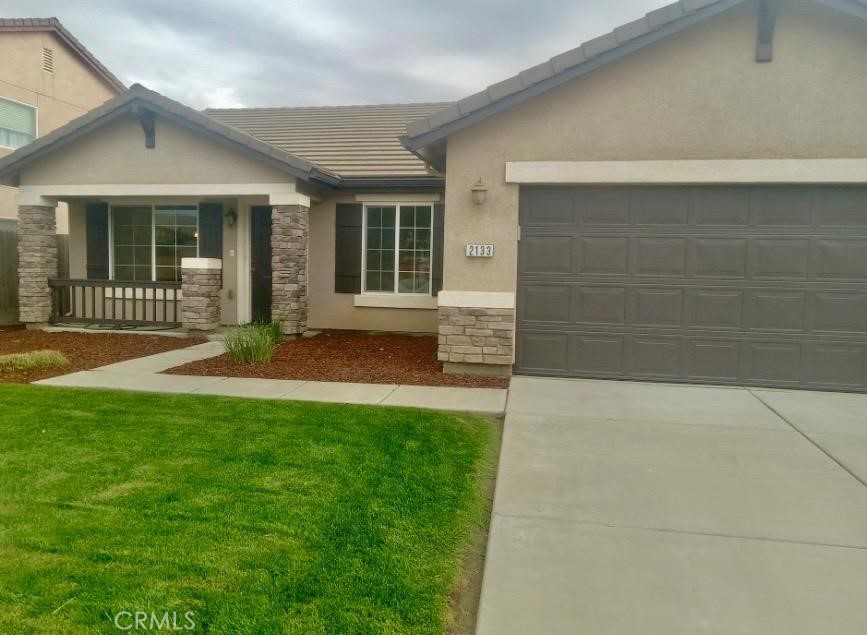 front view of a house with a yard