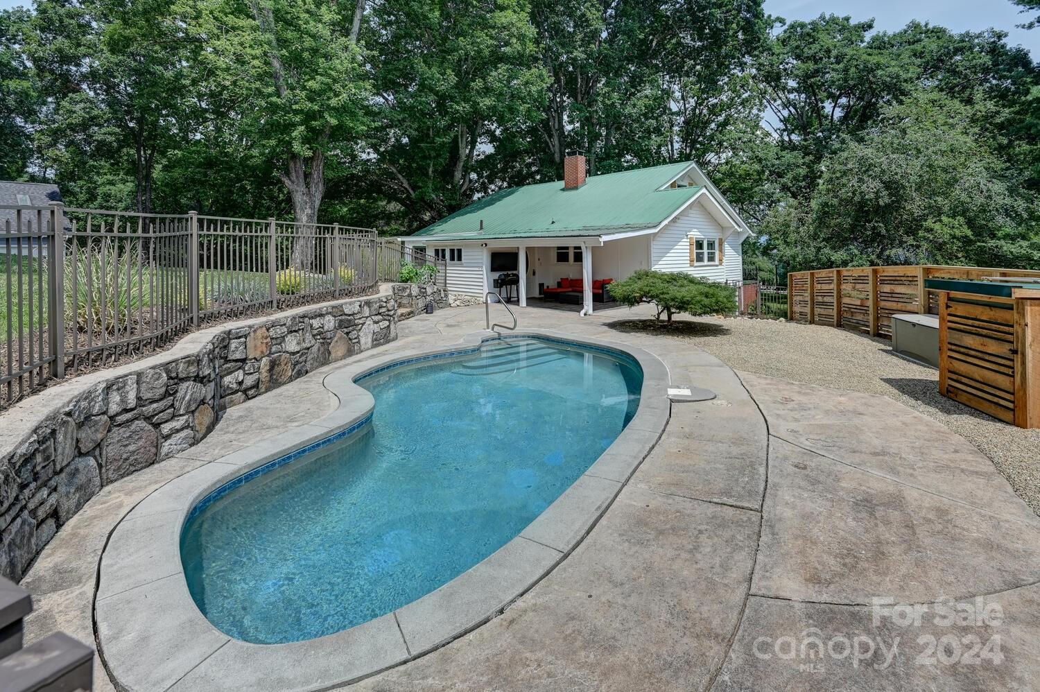 swimming pool view with a garden space