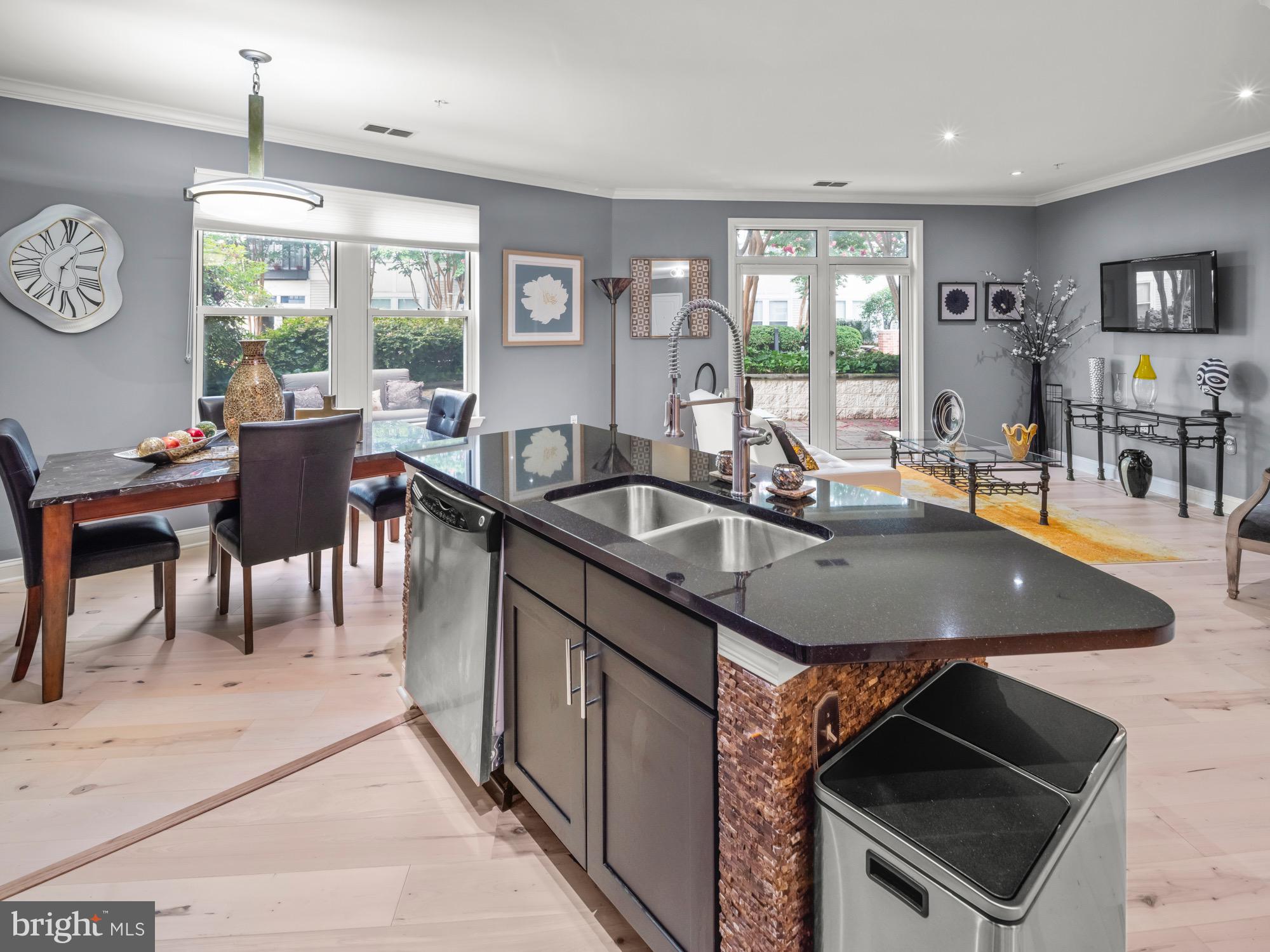 a kitchen with a table chairs sink and cabinets