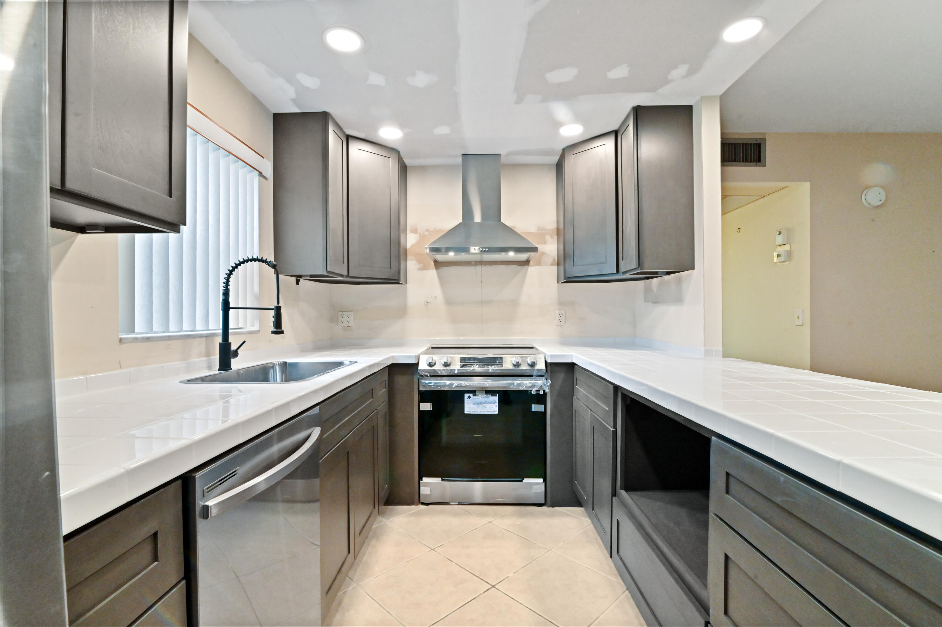 a kitchen with stainless steel appliances a sink stove and cabinets