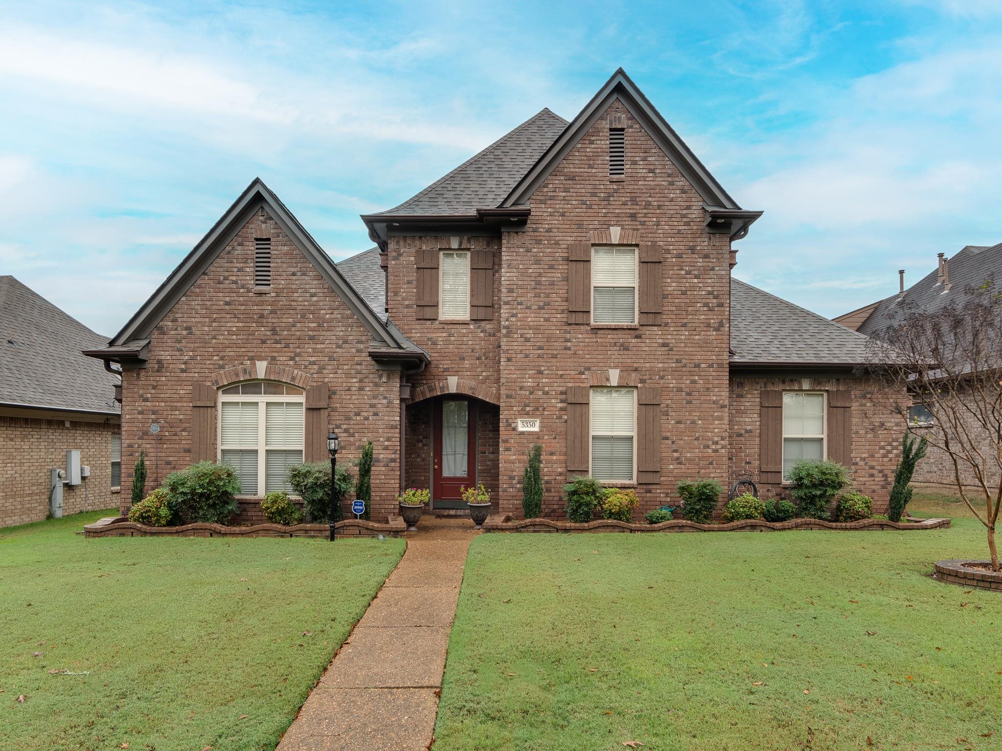 View of property with a front lawn