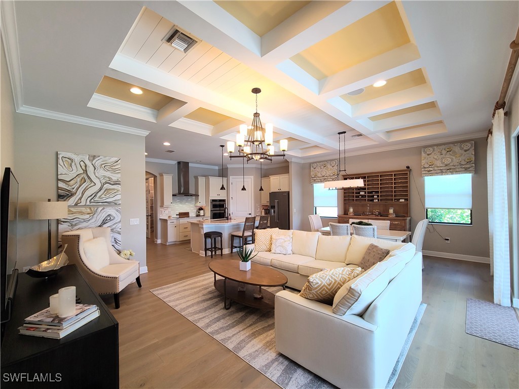 a living room with furniture and a chandelier