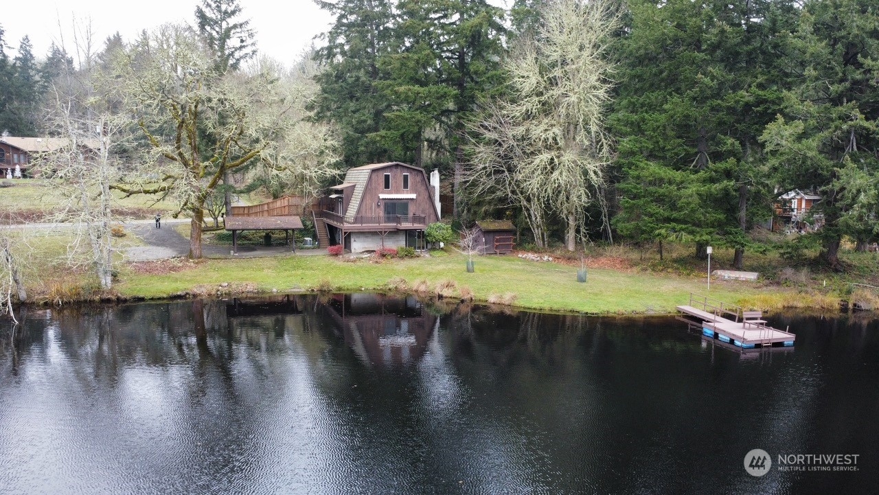 a backyard of a house with yard and lake view