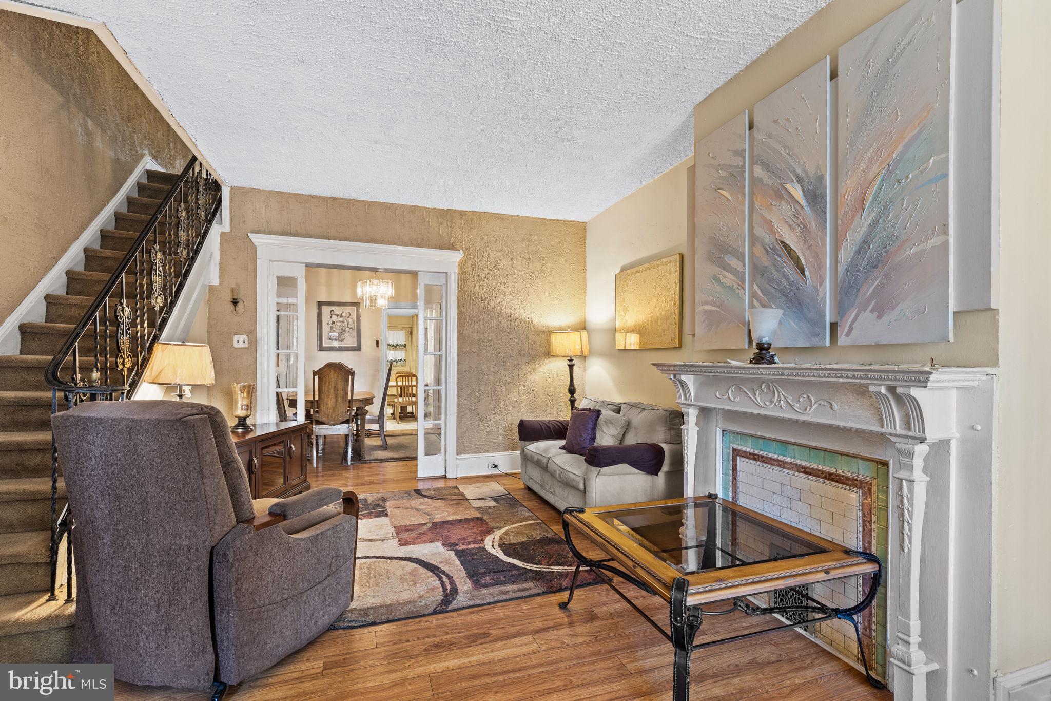 a living room with furniture a fireplace and a large window