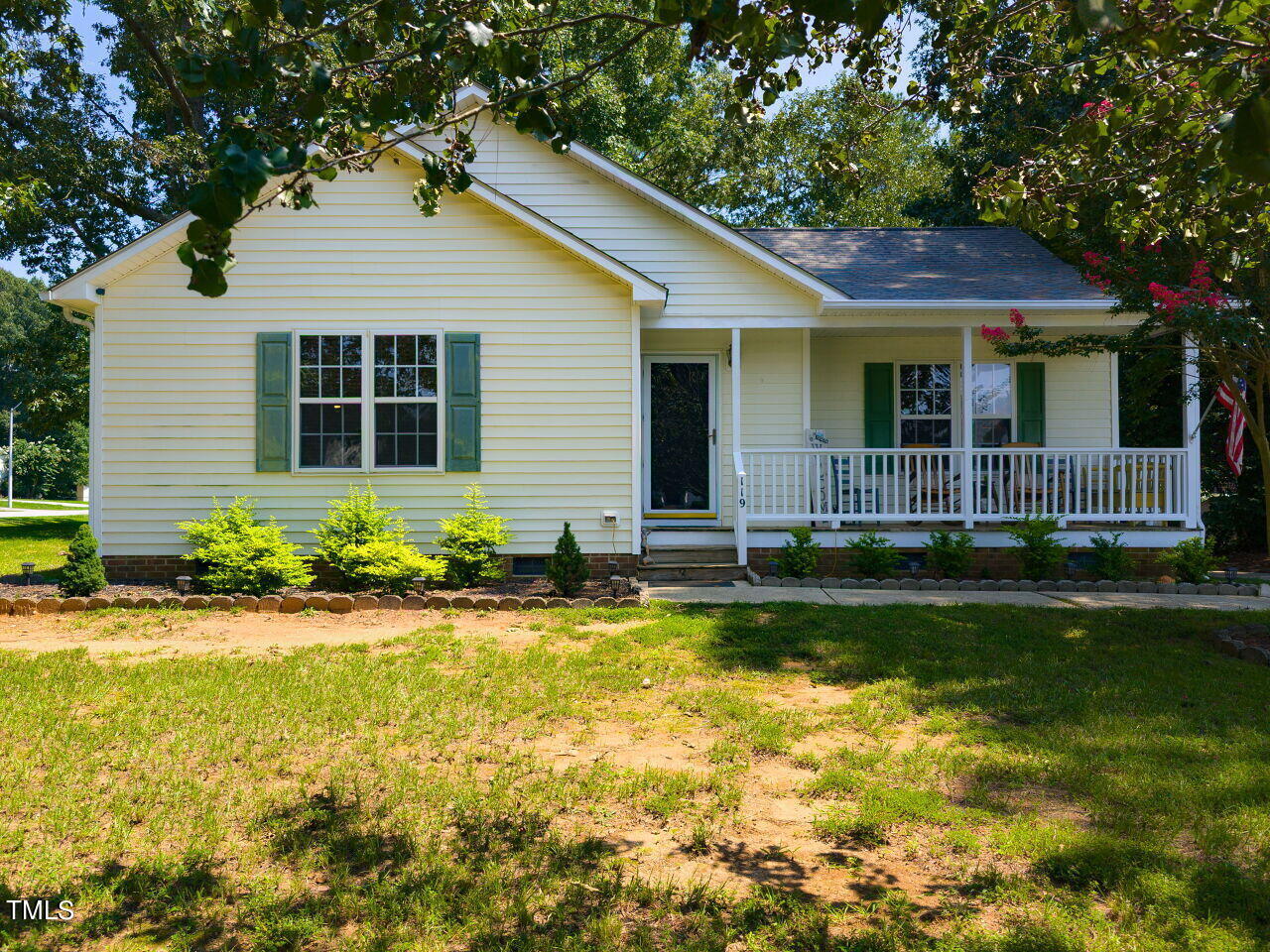 a front view of a house with a garden and porch