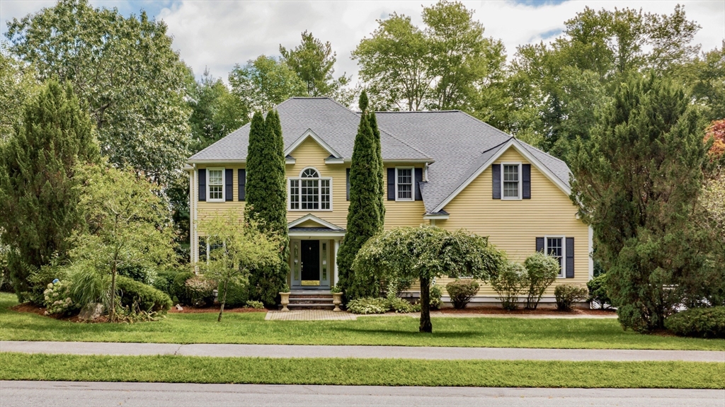 a front view of a house with a garden