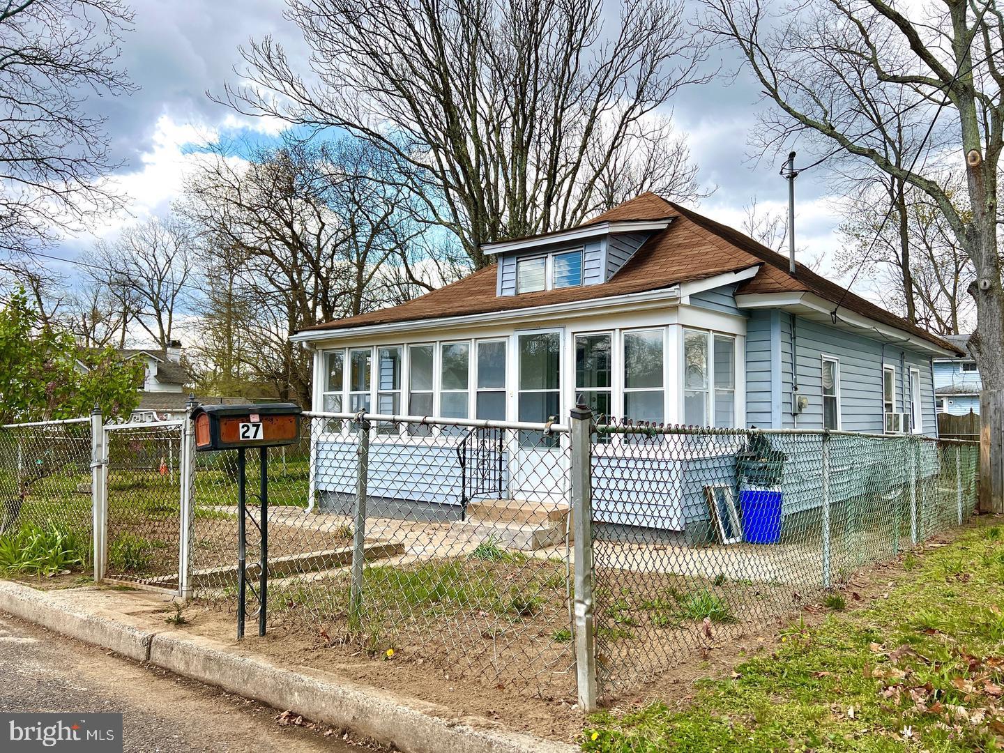 a view of house with a backyard