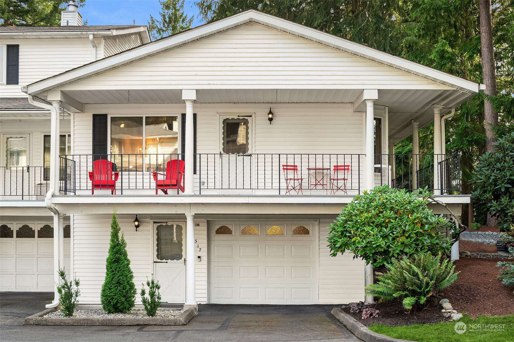 a front view of a house with potted plants