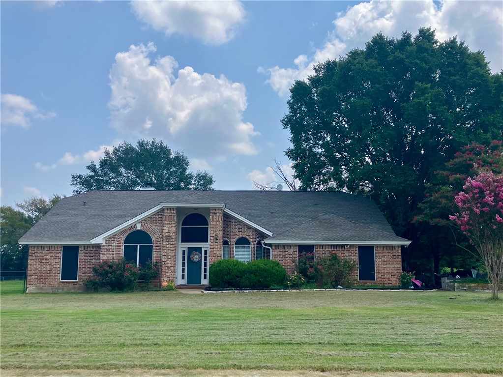 a front view of house with yard and green space