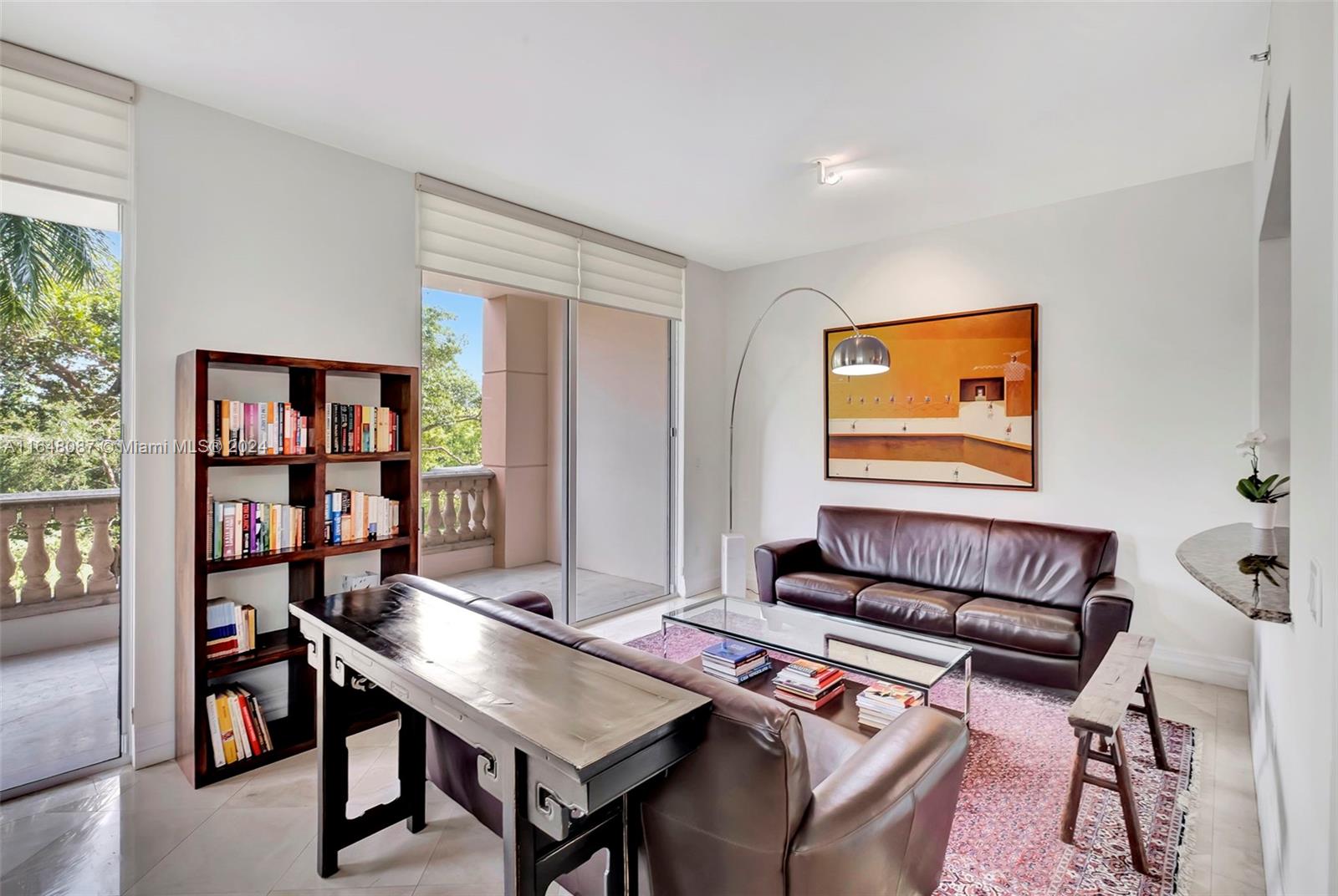 a living room with furniture and a book shelf