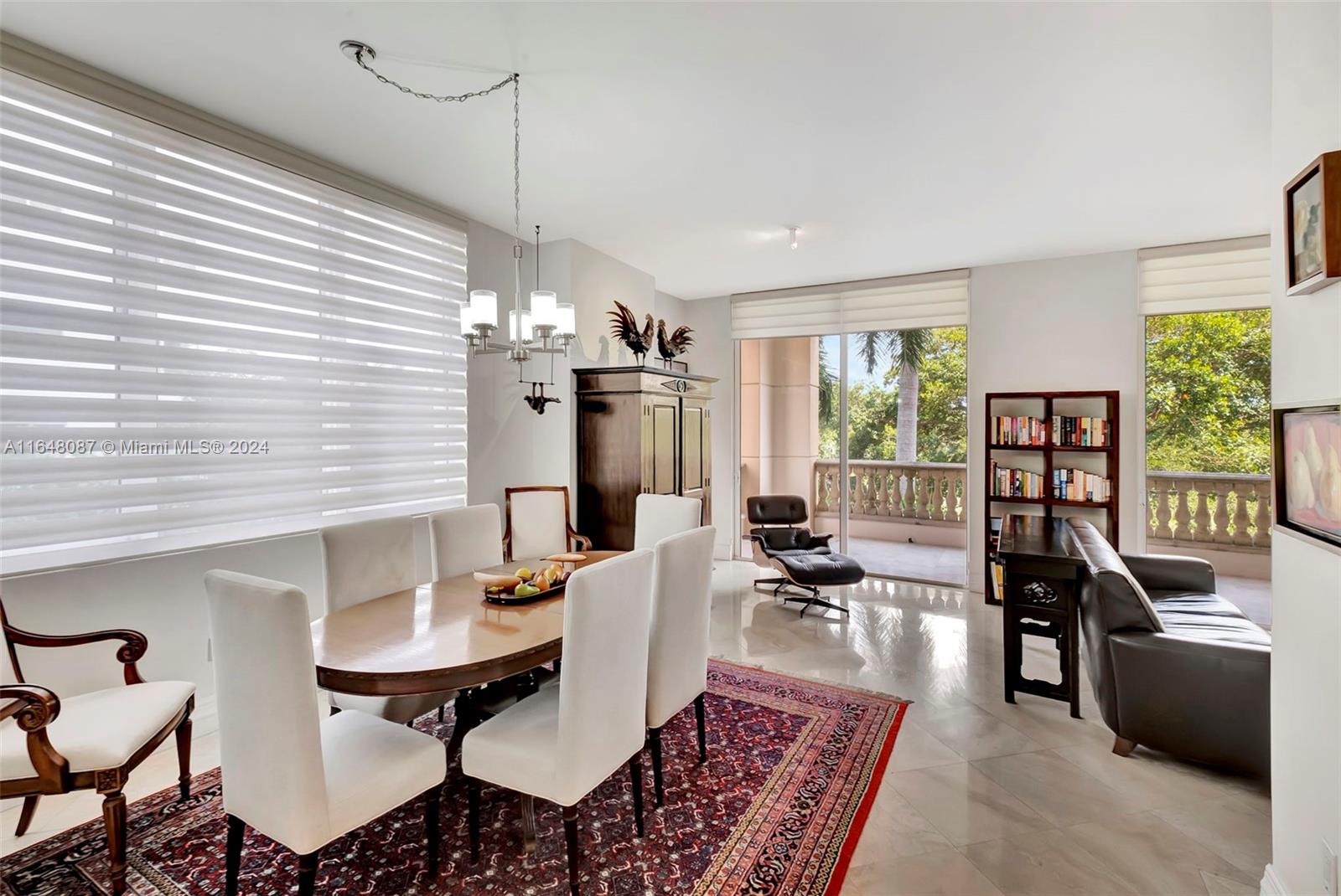 a living room with furniture kitchen view and large windows