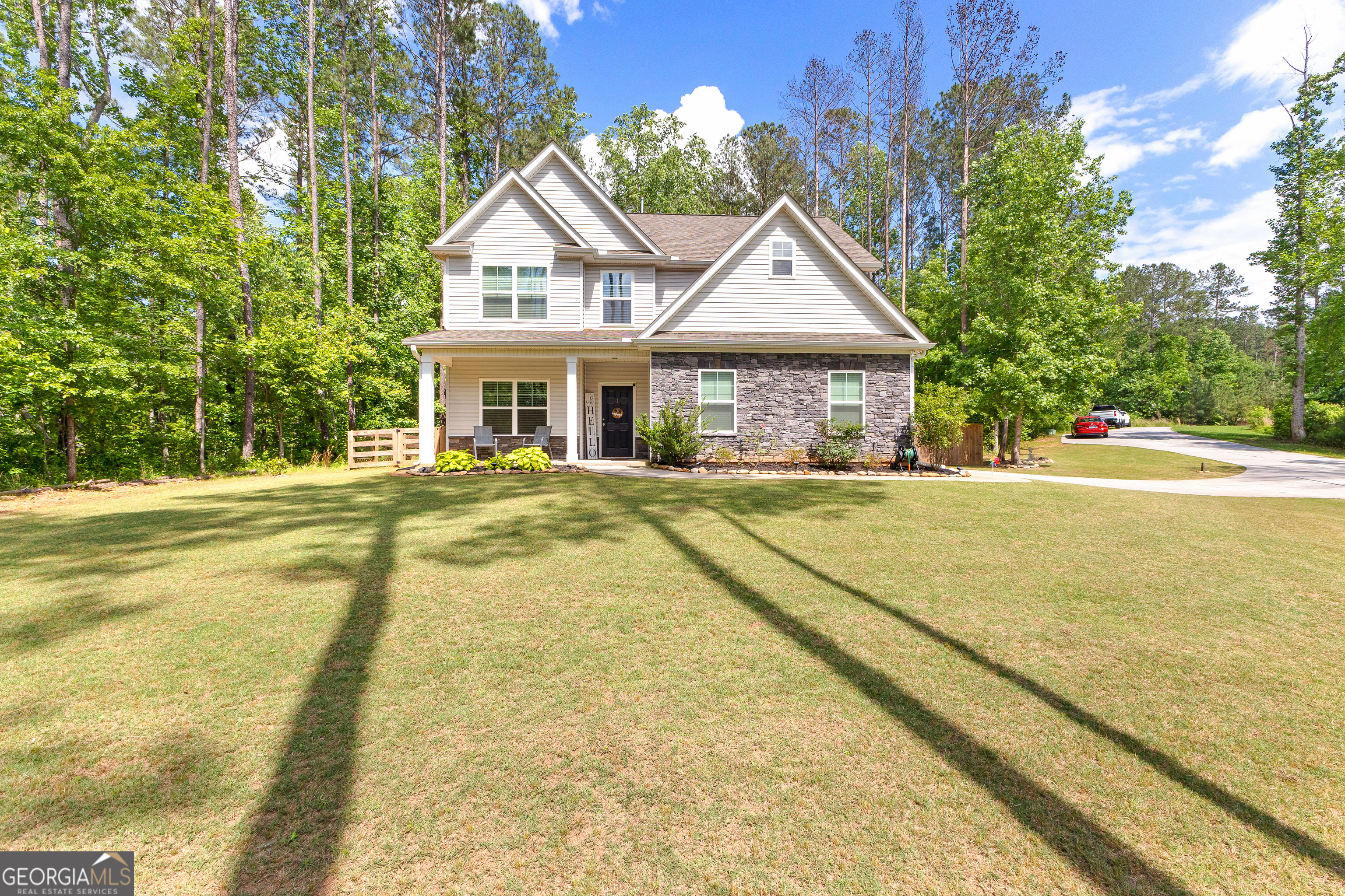 a view of house with yard and swimming pool