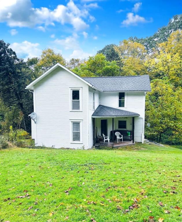 a view of a house with a yard porch and sitting area