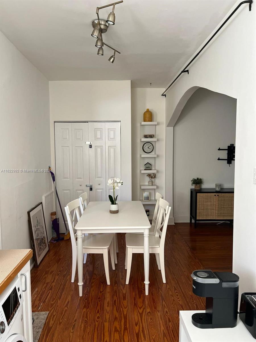 a view of a dining room with furniture and wooden floor