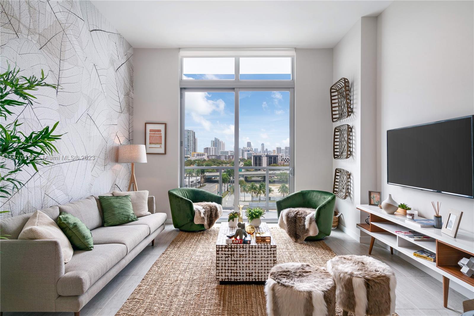 a living room with furniture potted plant and a large window