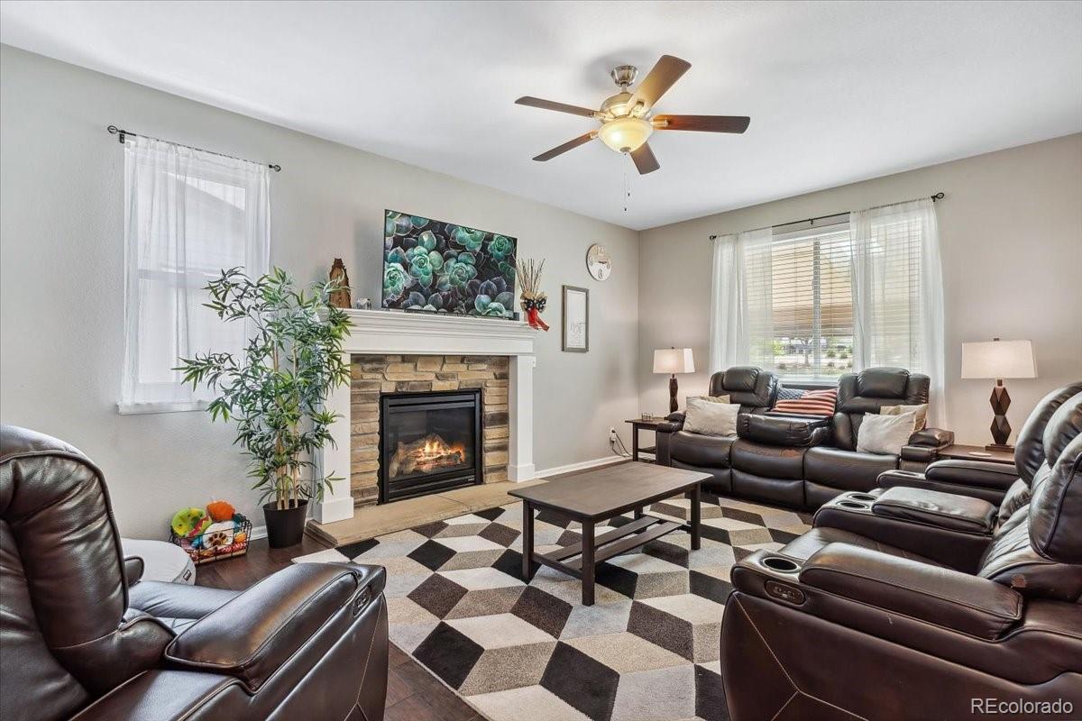 a living room with furniture and a fireplace