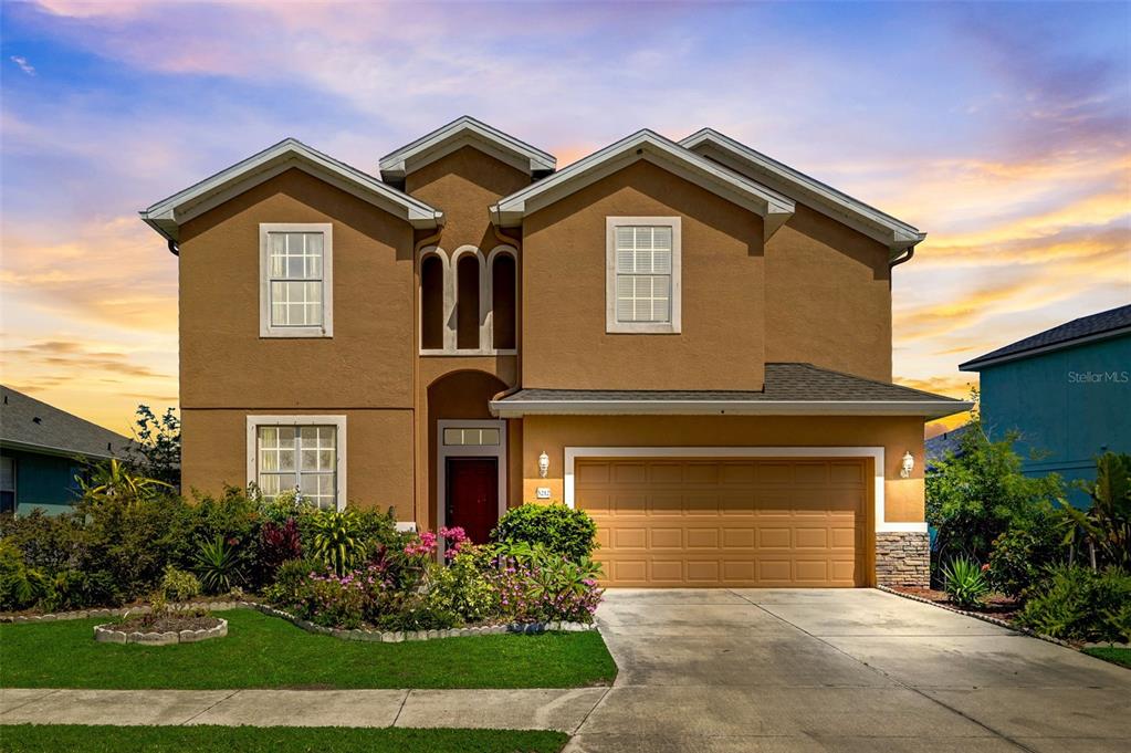 a front view of a house with a yard and garage