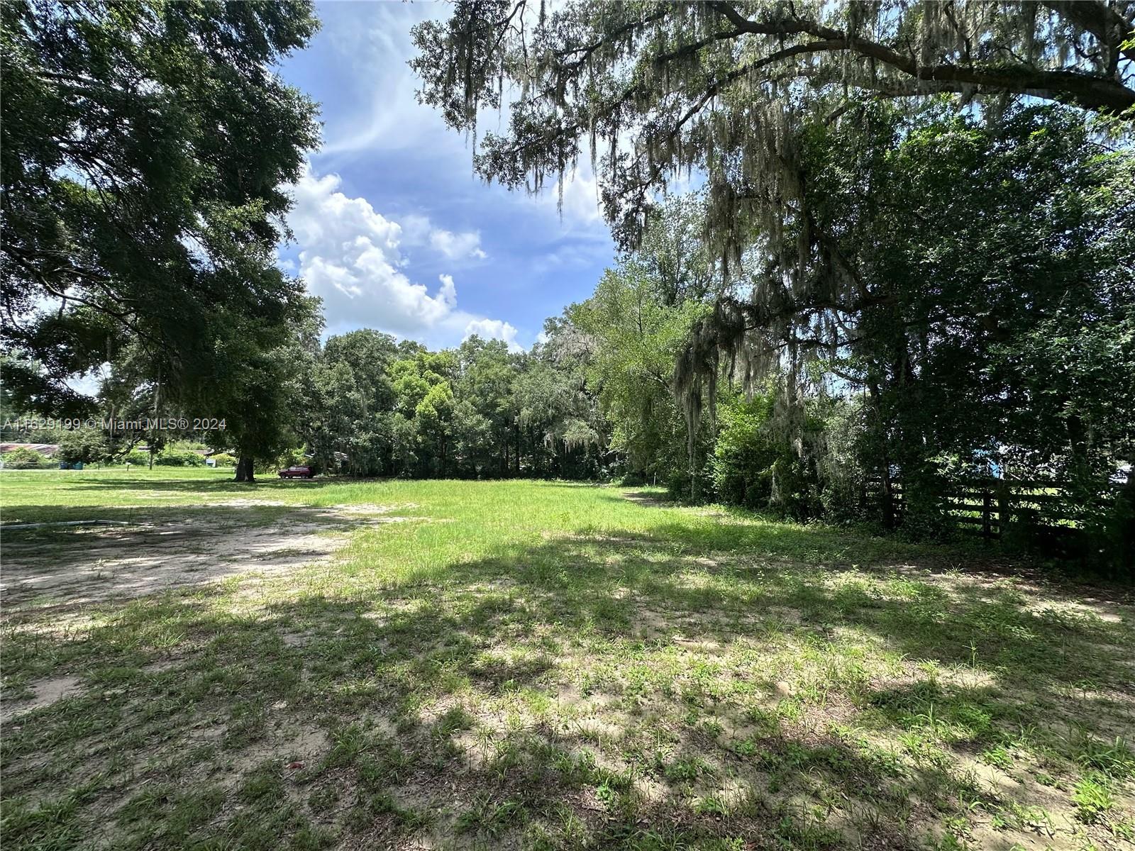 a view of field with trees in the background