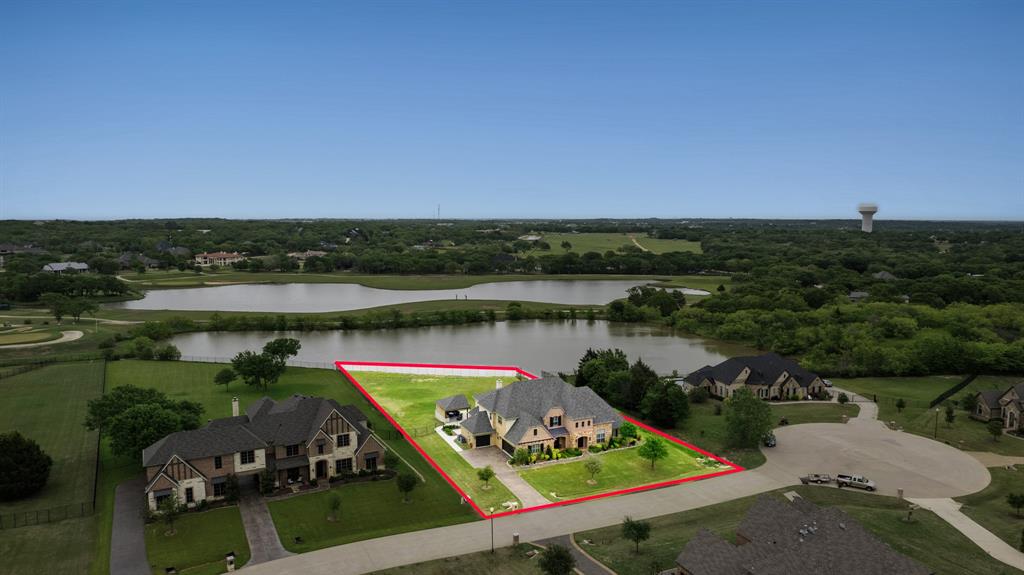 an aerial view of lake and residential houses with outdoor space