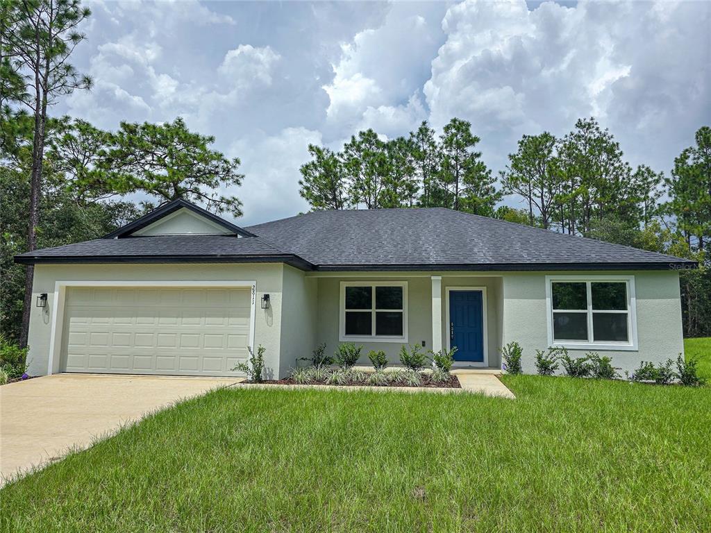 a front view of a house with a garden and yard