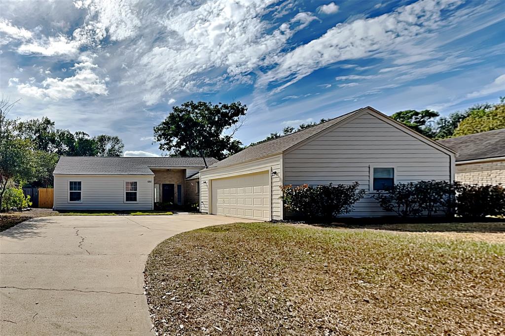 a front view of house with yard and trees around