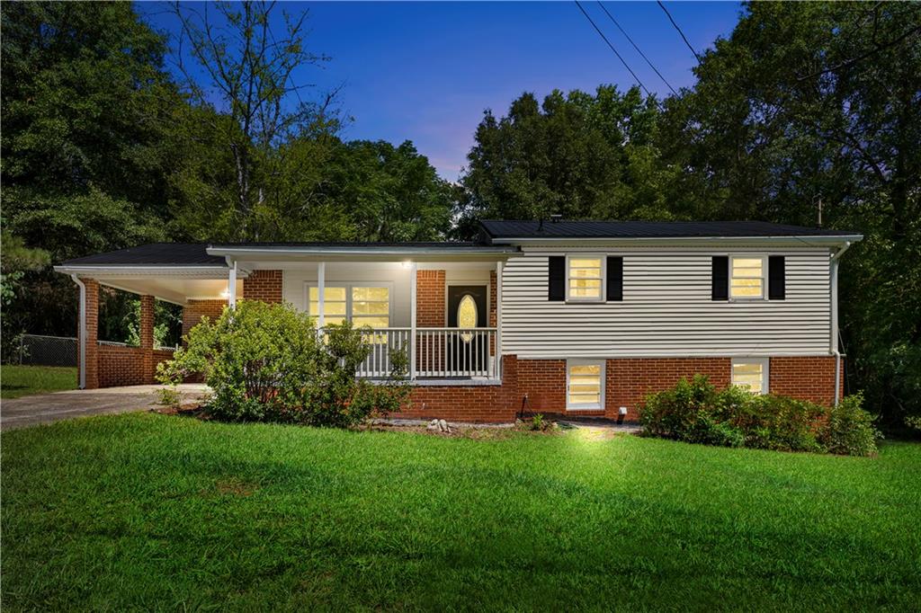 a view of house with a yard