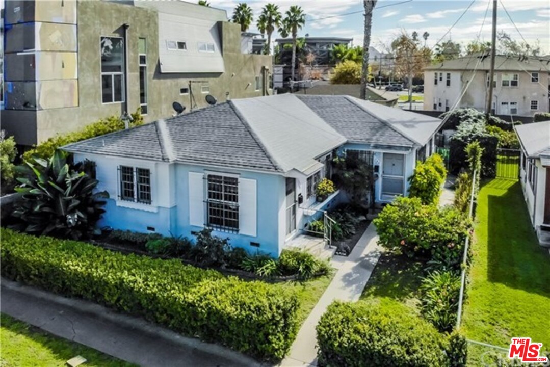 a aerial view of a house next to a yard