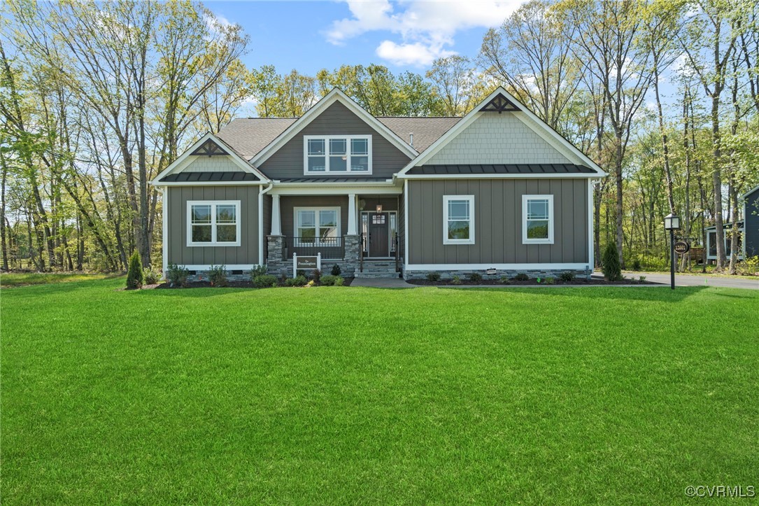 a front view of a house with a garden and trees