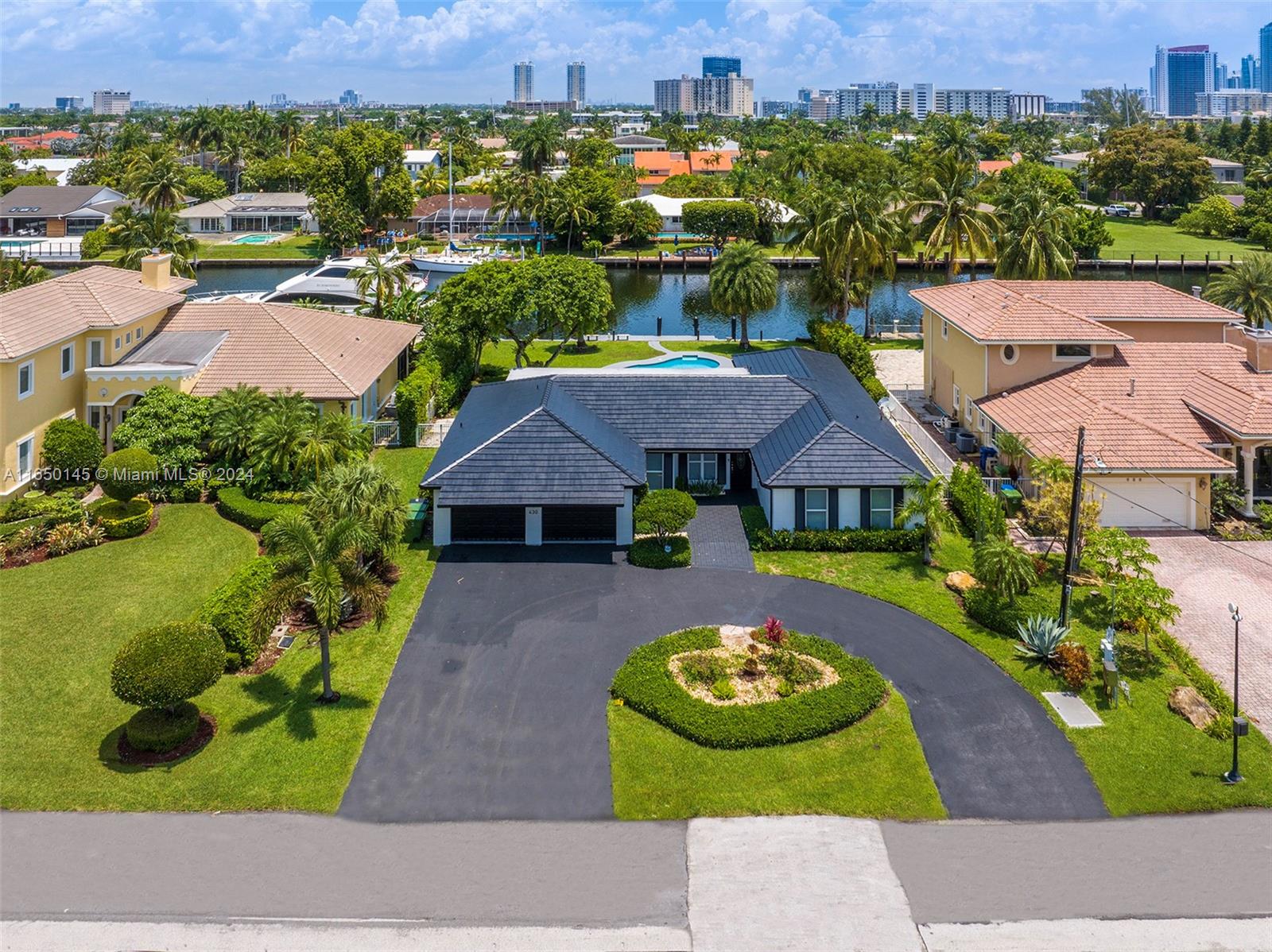 an aerial view of a house with garden space and lake view