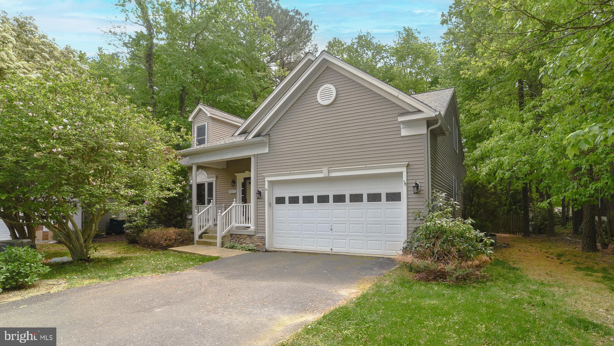 a view of a house with a yard and tree s