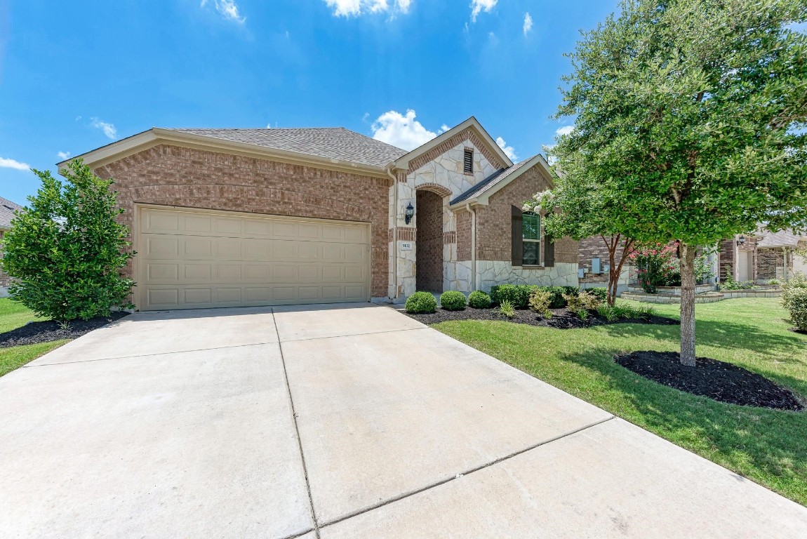 a front view of a house with a yard and garage