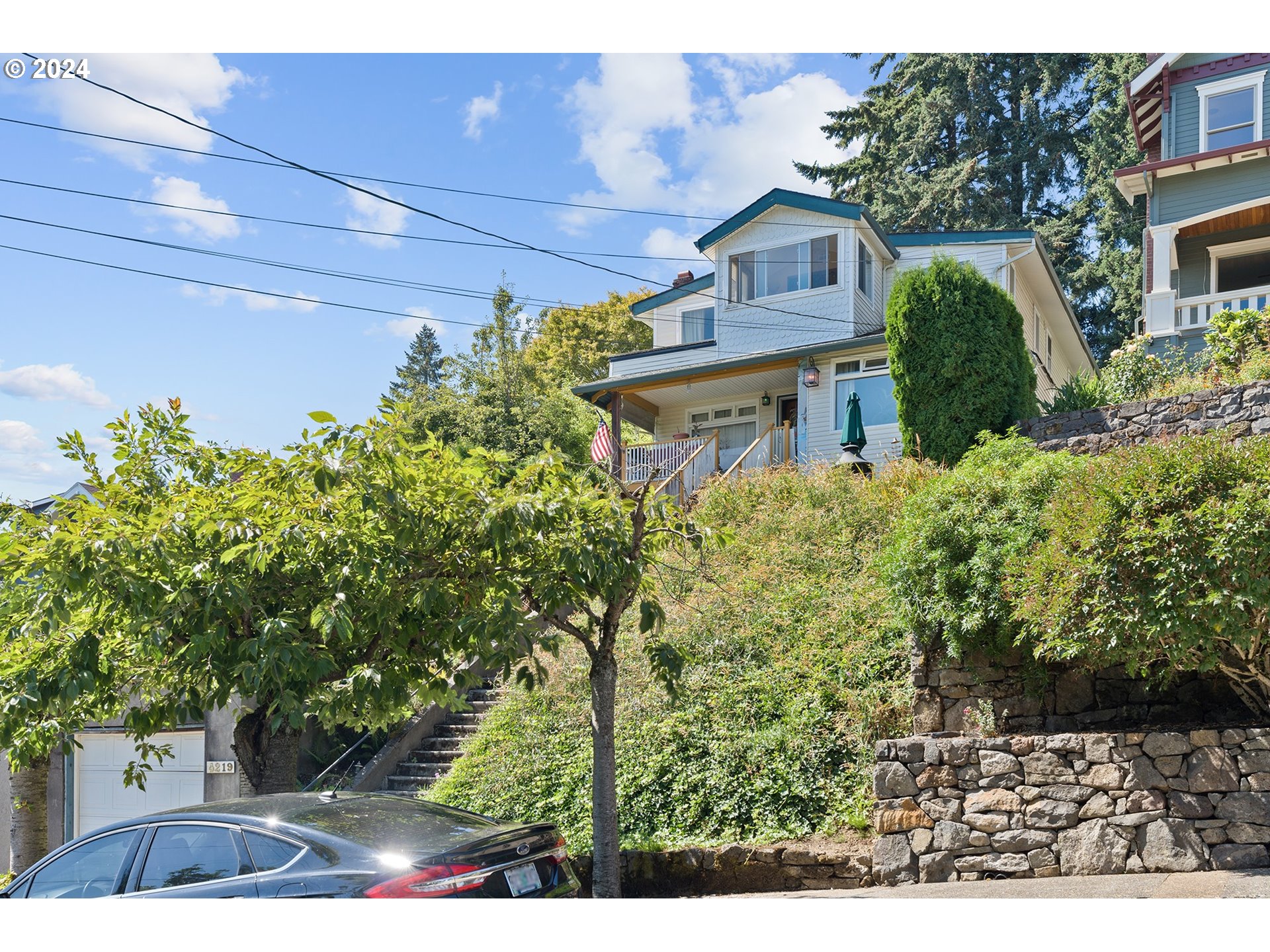 a front view of a house with a garden