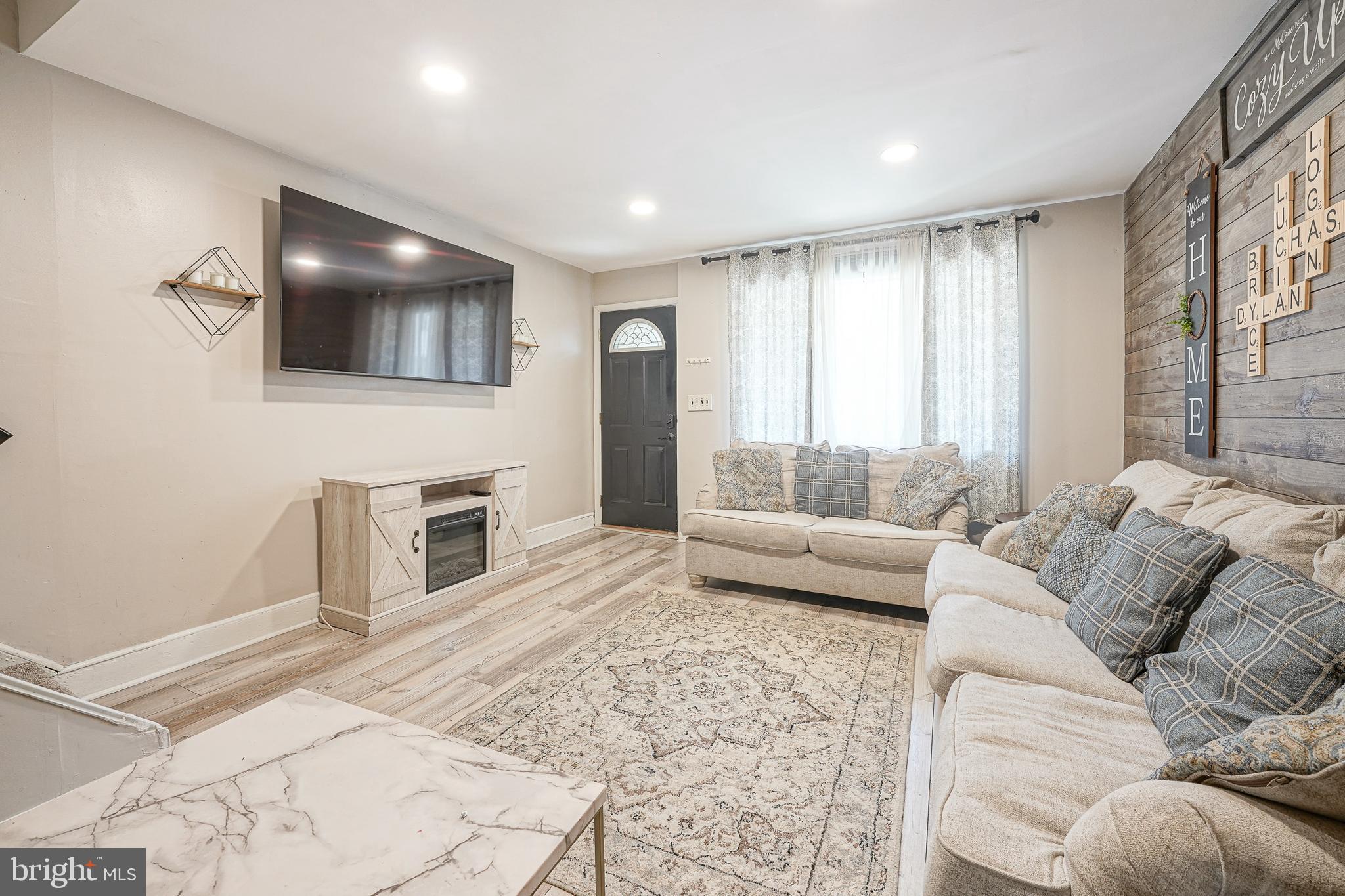 a living room with furniture and a fireplace