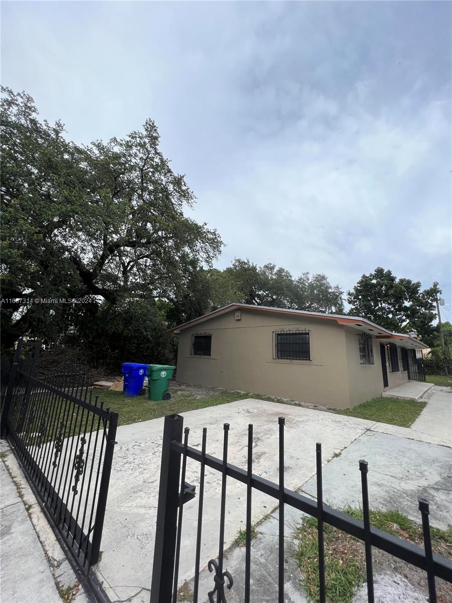 a view of house with backyard and deck