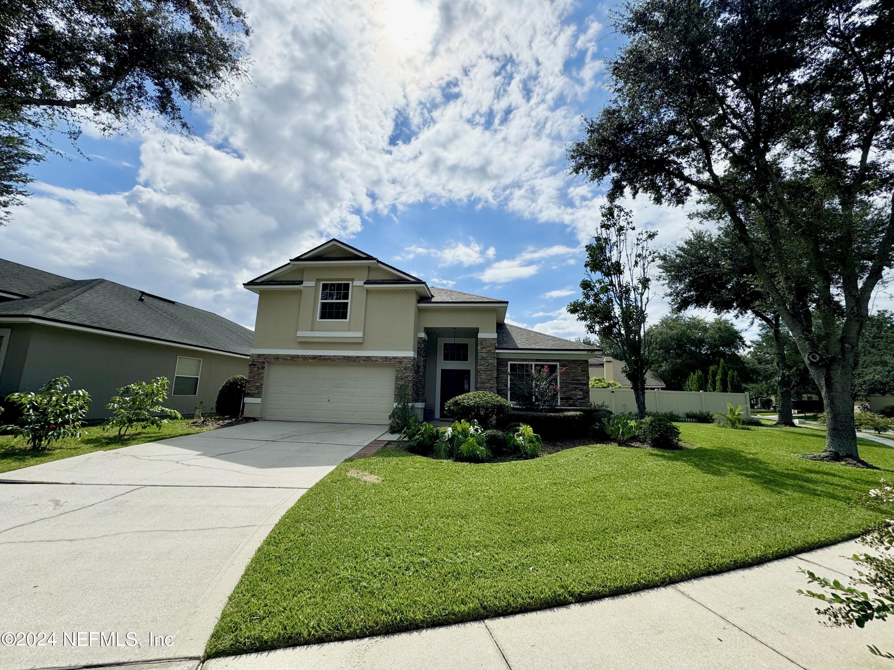 a front view of a house with garden