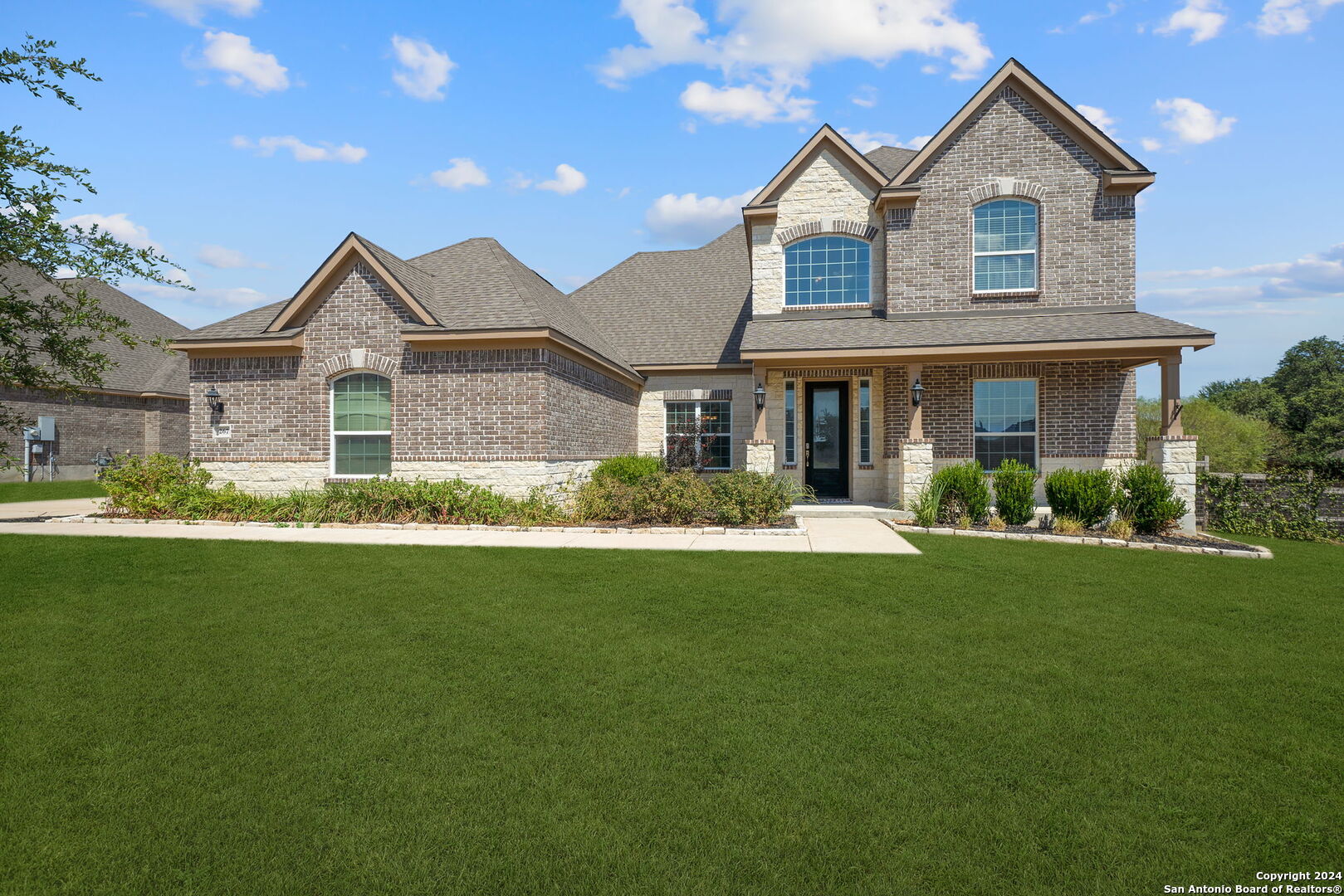 a front view of a house with a yard