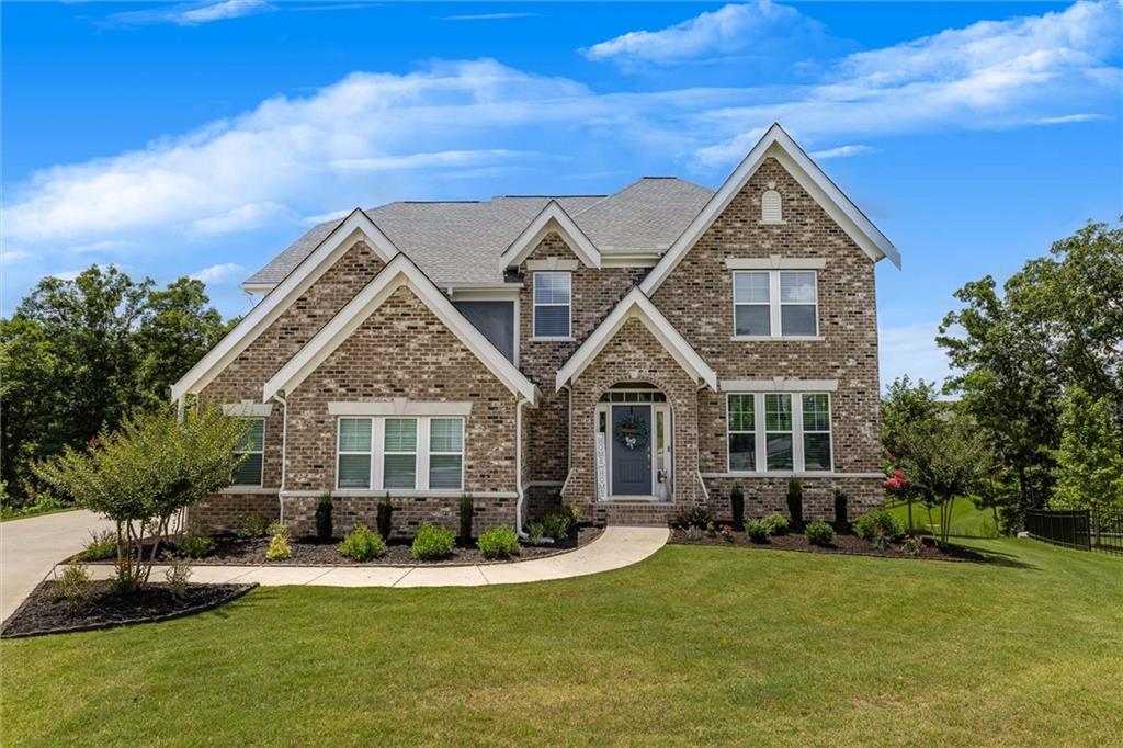 a front view of a house with a yard