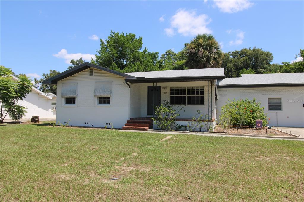 a front view of house with yard and green space