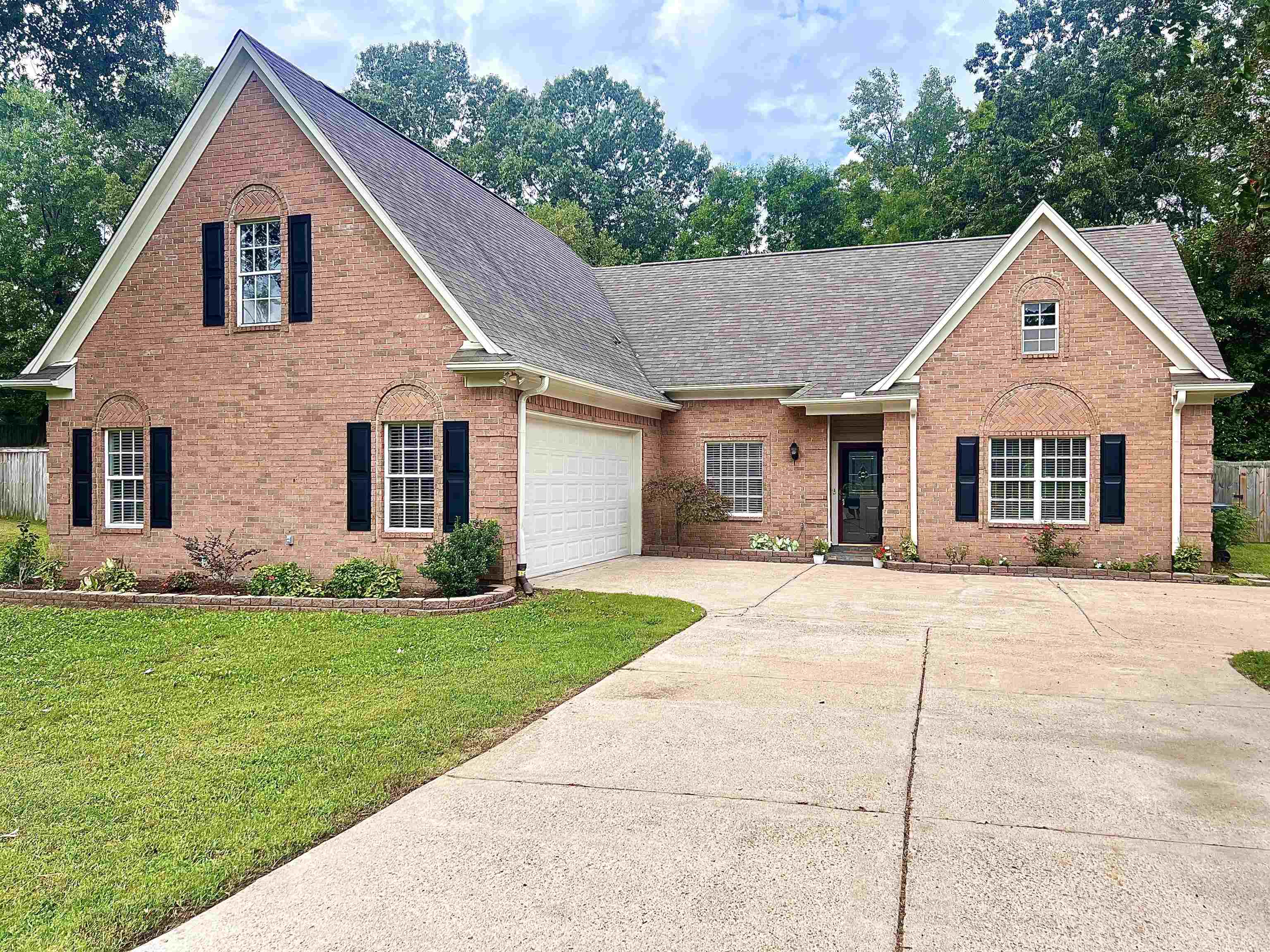 View of front of home featuring a garage and a front yard