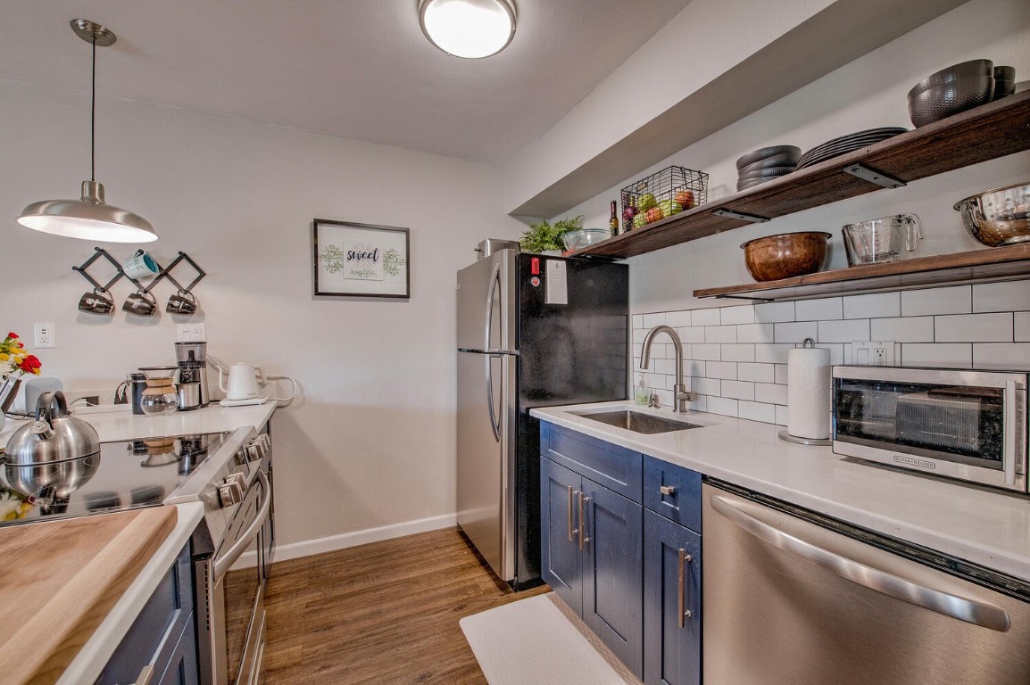 a kitchen with stainless steel appliances granite countertop a stove and a sink