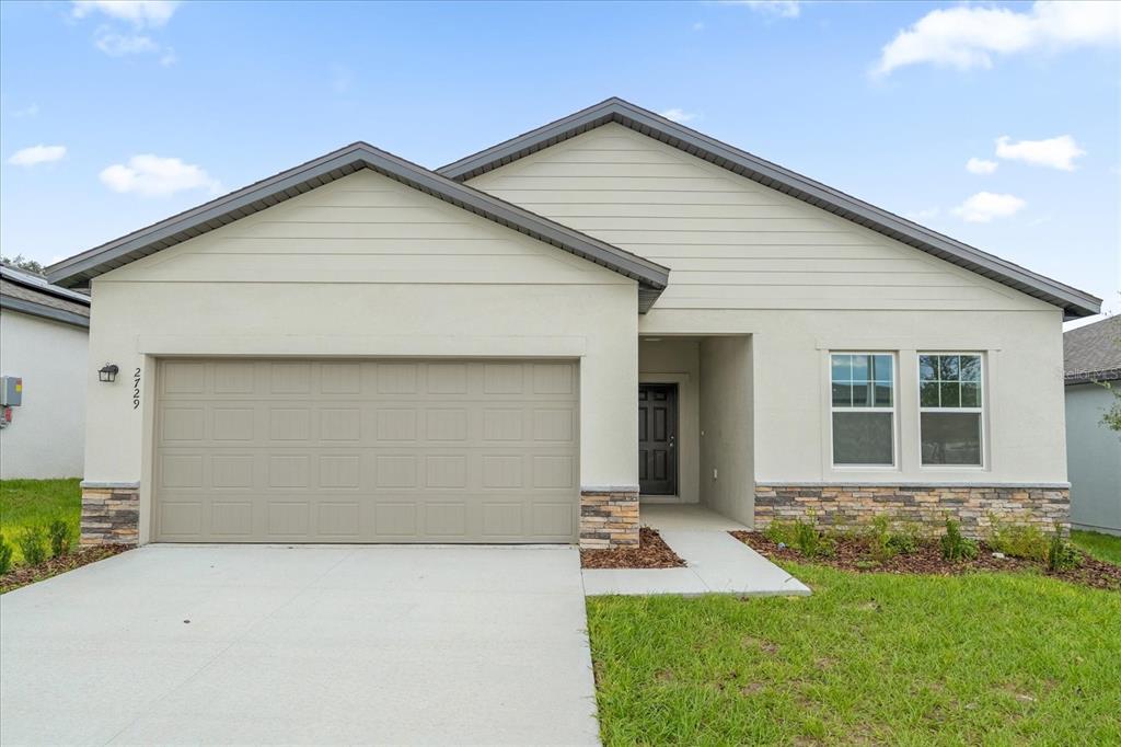 a front view of a house with yard