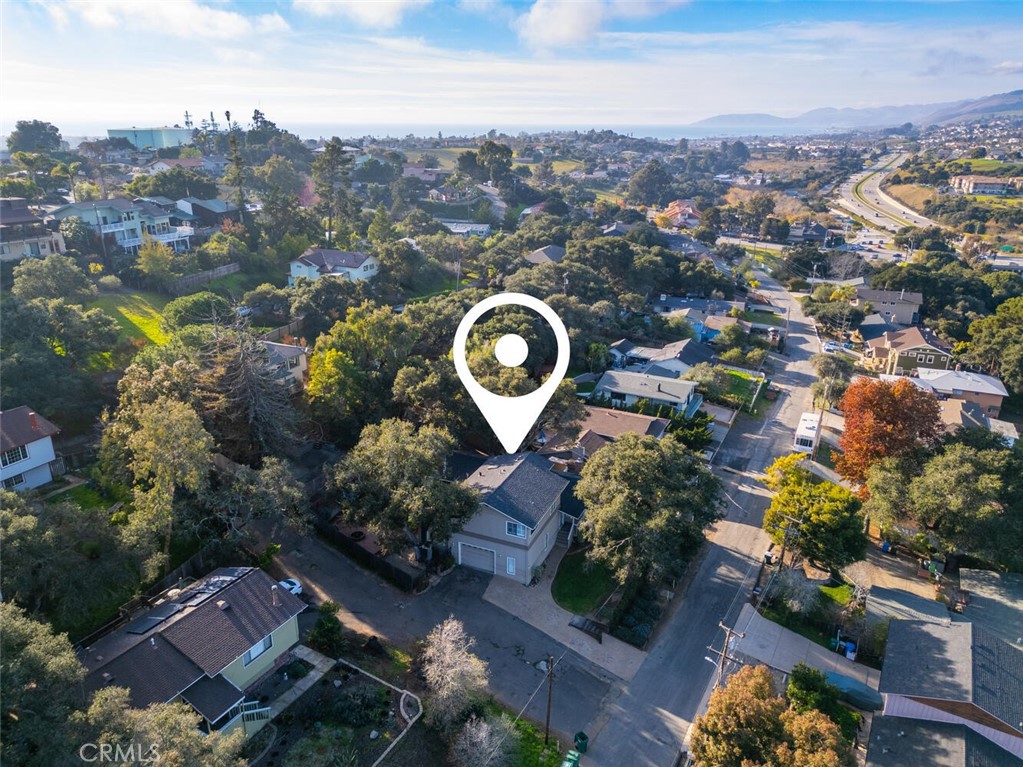 an aerial view of a house with yard