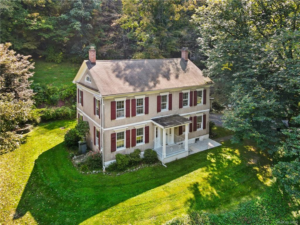 a aerial view of a house with a yard table and chairs