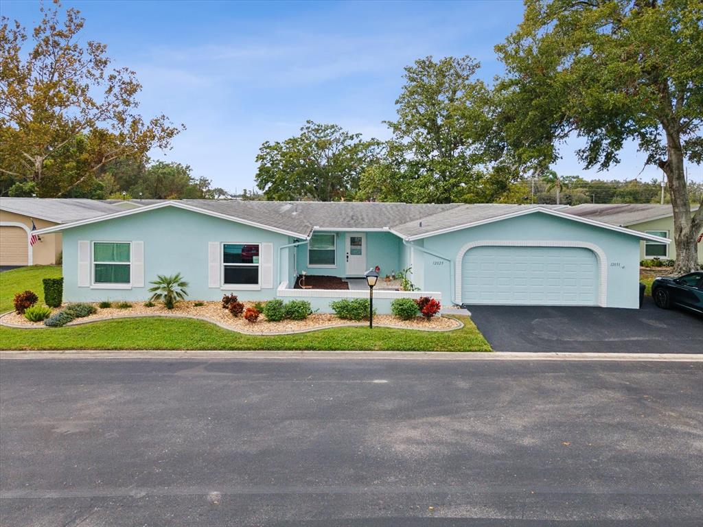 a view of a house with a yard and a garage