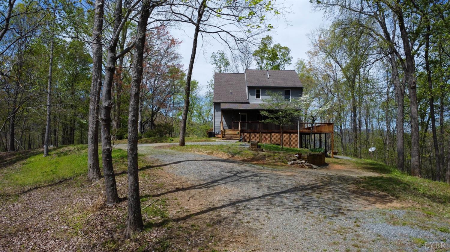 a view of a house with a yard and tree s