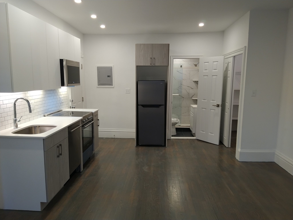 a kitchen with stainless steel appliances a refrigerator and a sink