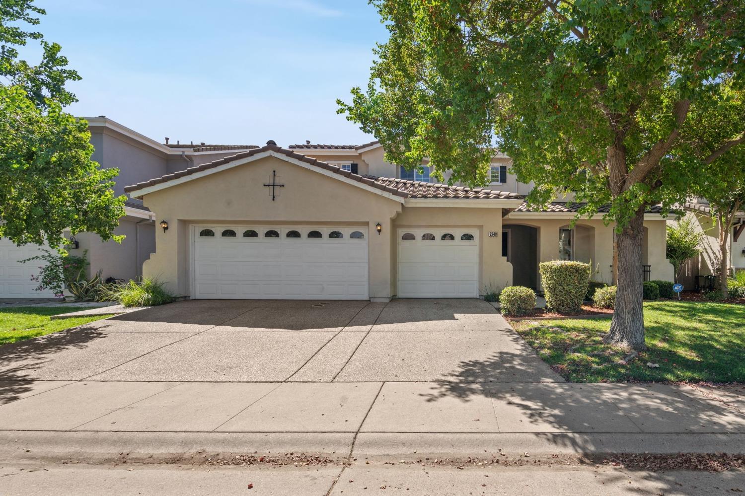 a front view of a house with a yard and a garage